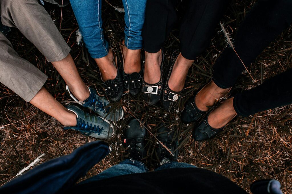 A group of friends displaying their unique footwear in an outdoor circle at Cianjur, West Java.